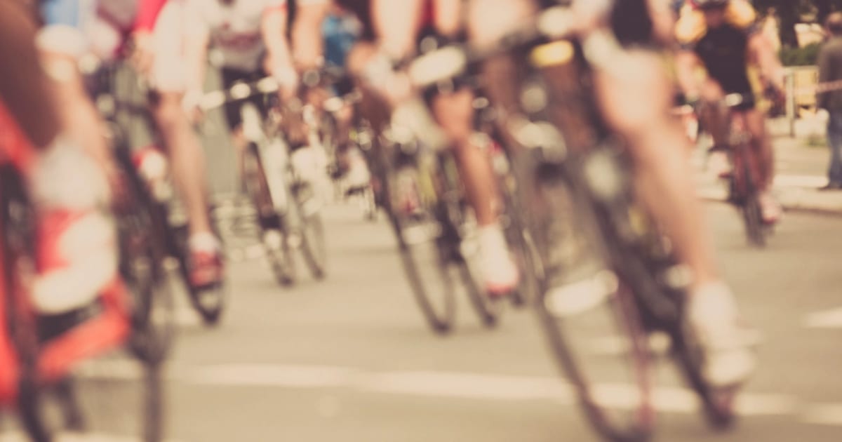 A pack of road cyclists riding close together